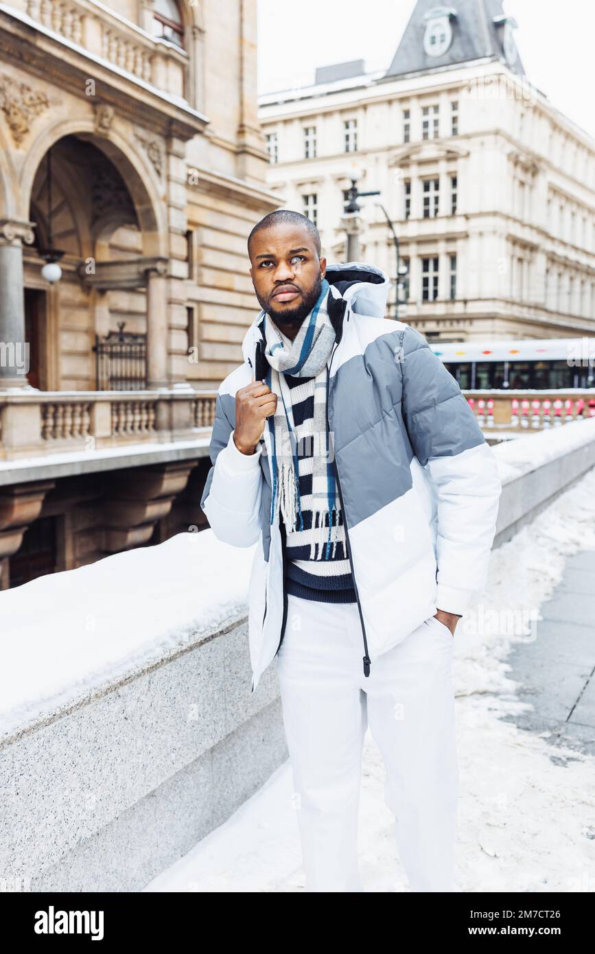 Young African man in casual white and blue clothes, striped sweater. Winter  season street portrait with snow. Lifestyle, city life concept. Full body  view, copy space Stock Photo - Alamy