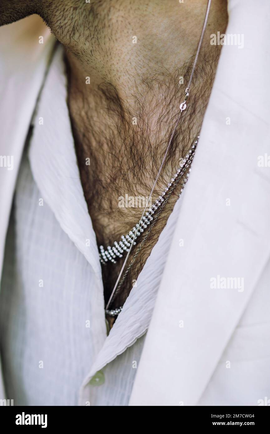 Midsection of man wearing necklaces and chain Stock Photo