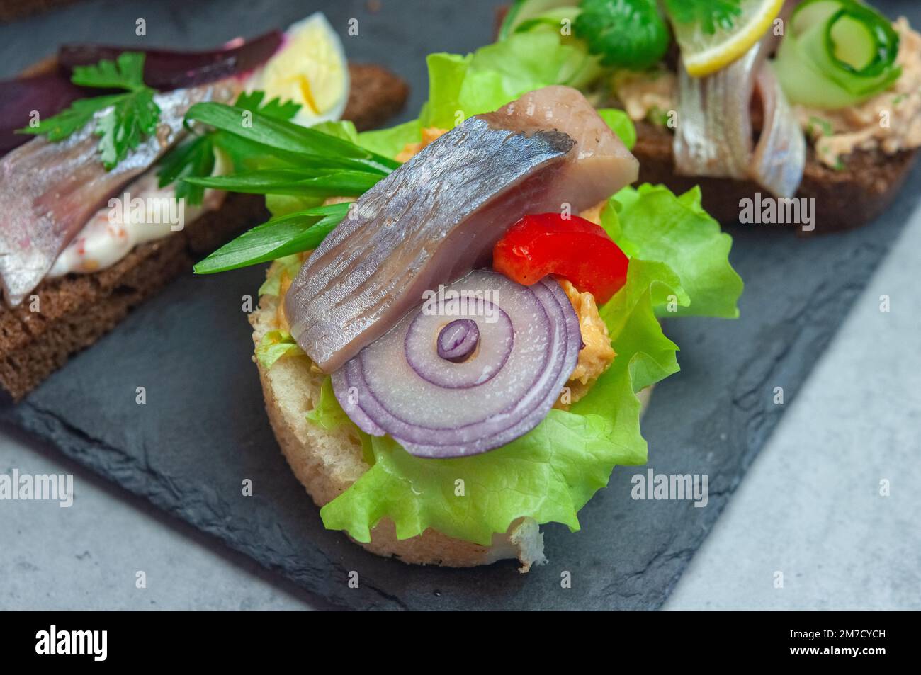 Appetizer with salted herring, pate, onion, egg, lettuce, tomato and beetroot. Scandinavian