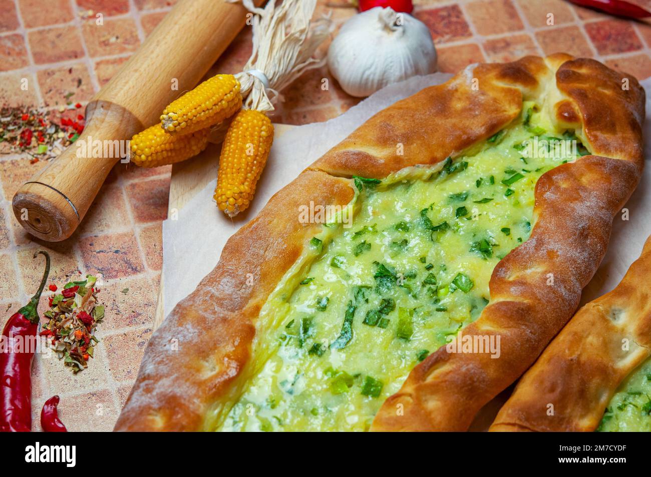 Pide with cheese and potatoes. Turkish pizza. Pide - Delicious vegetarian pide, beautifully arranged oriental pizza. Stock Photo