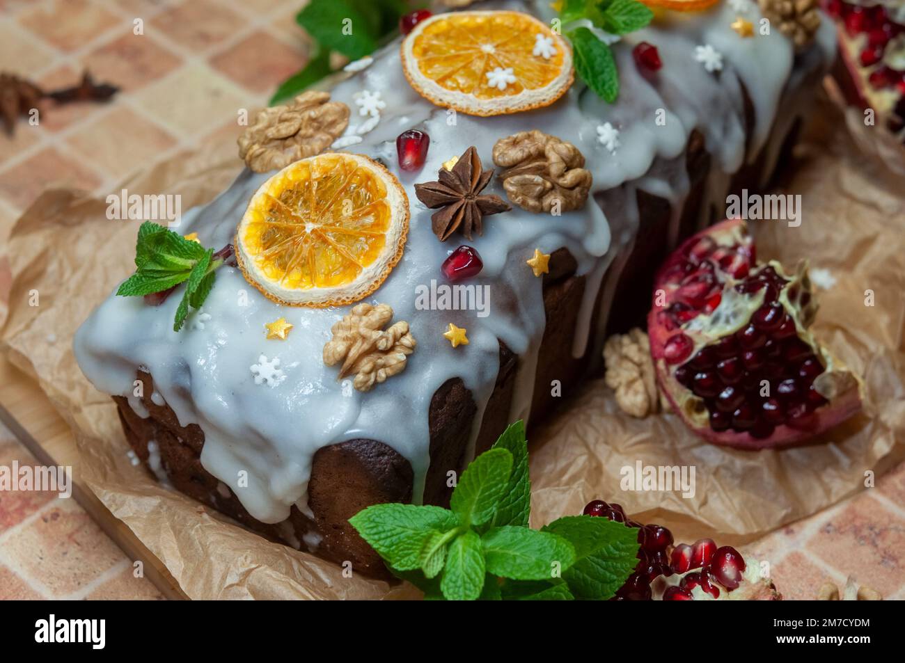 Christmas stollen with candied fruit and dried fruits on parchment. Stollen traditional German