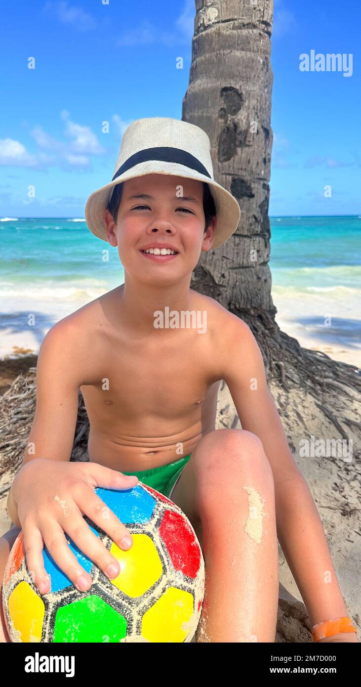 Portrait of a cute European teen boys wearing swimming shorts. The boy