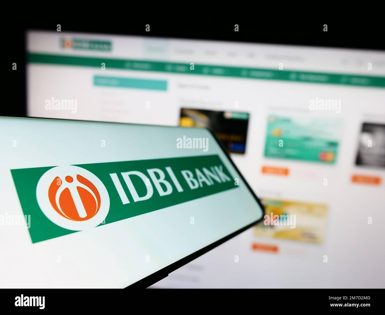Smartphone with logo of Indian financial company IDBI Bank Limited on screen in front of business website. Focus on left of phone display. Stock Photo