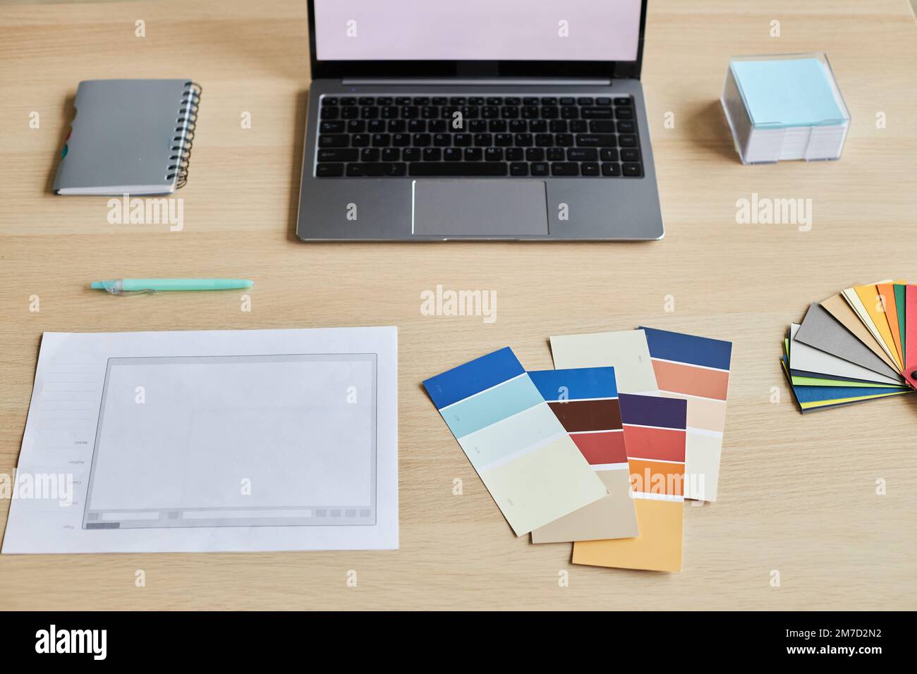 Top view of designers workplace with palette swatches and laptop, copy space Stock Photo