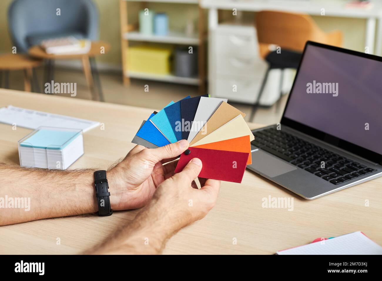 Close up of male designer holding color swatches while working in office, copy space Stock Photo