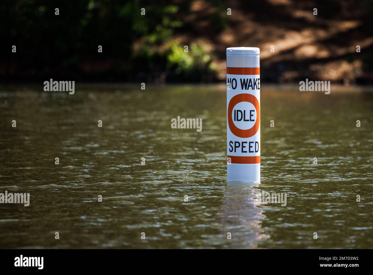 No wake safety buoy on lake alerting boaters to idle speed restriction
