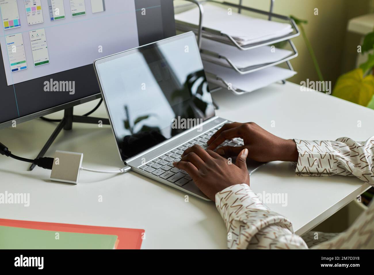 Close up of black young woman typing at laptop keyboard while working on UX design project in home office, copy space Stock Photo