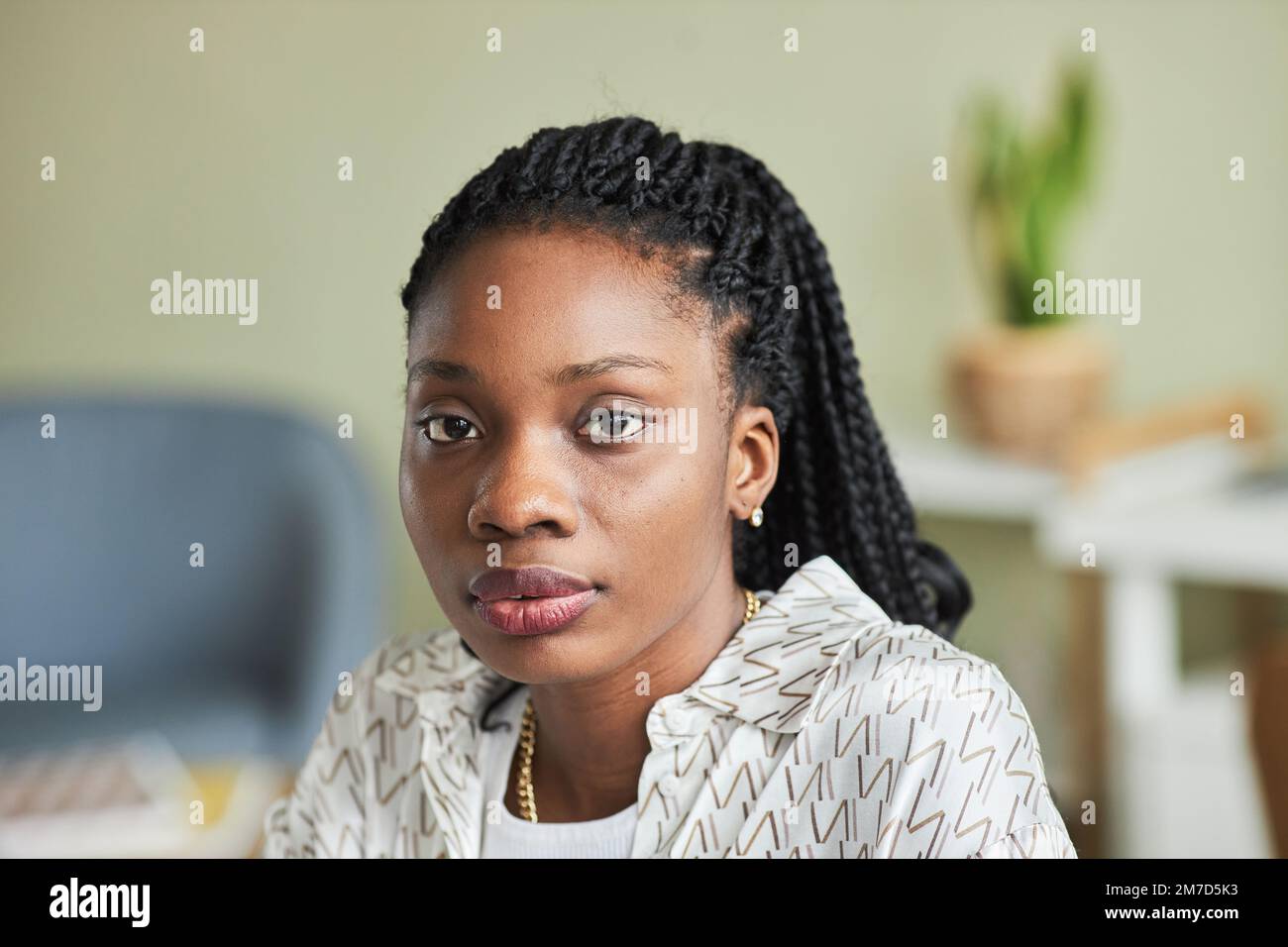 Close up portrait of black young woman looking at camera in minimal ...