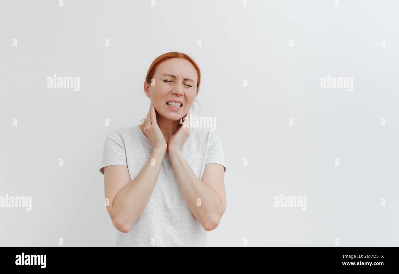 Young woman with pain in head. Sore throat,toothache. Headache migraine