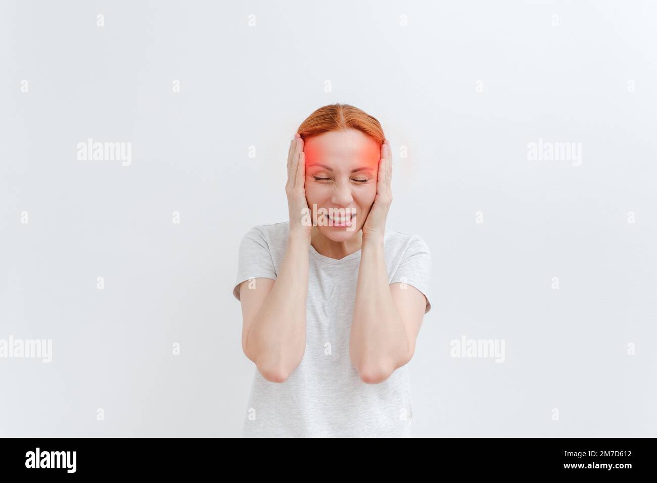 Young woman with headache. Red mark. Pain in head, temple, problem with