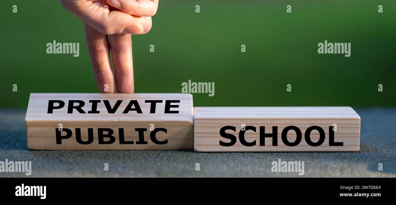 Hand turns dice and changes the expression 'public school' to 'private school'. Stock Photo