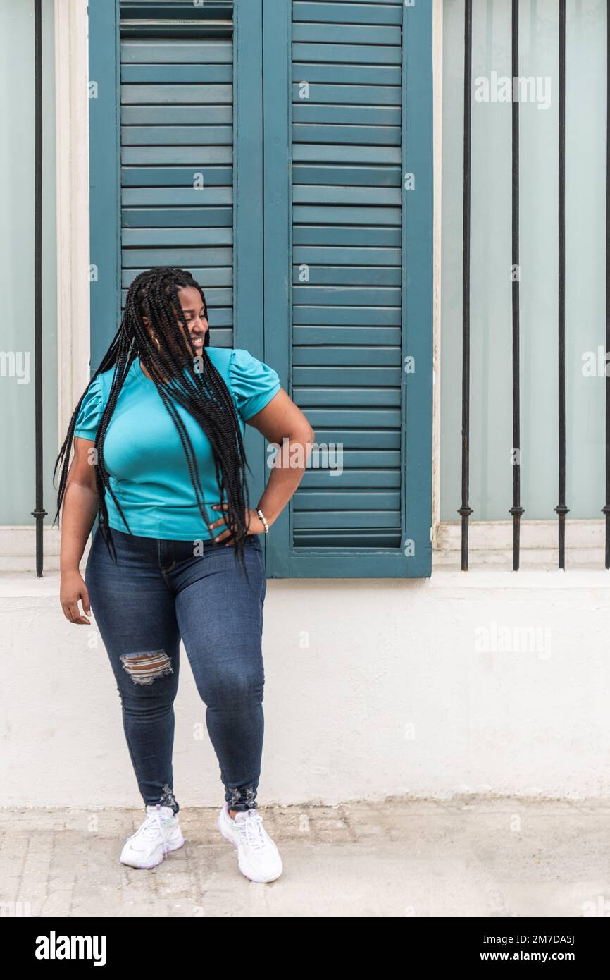 expressive woman with long braids dancing in the city very happy Stock ...