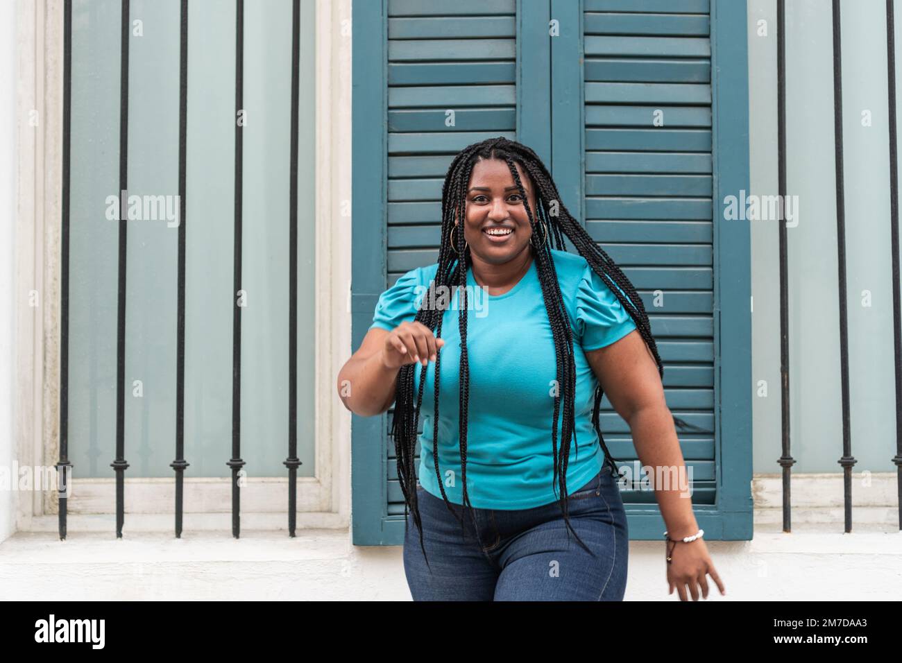 African woman with long braids dancing in the city very happy Stock ...