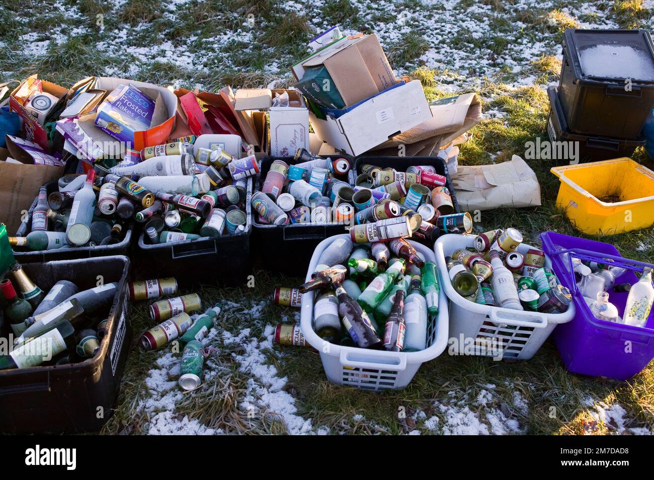 Kerb side recycling bins full of cans, paper and cardboard waiting for