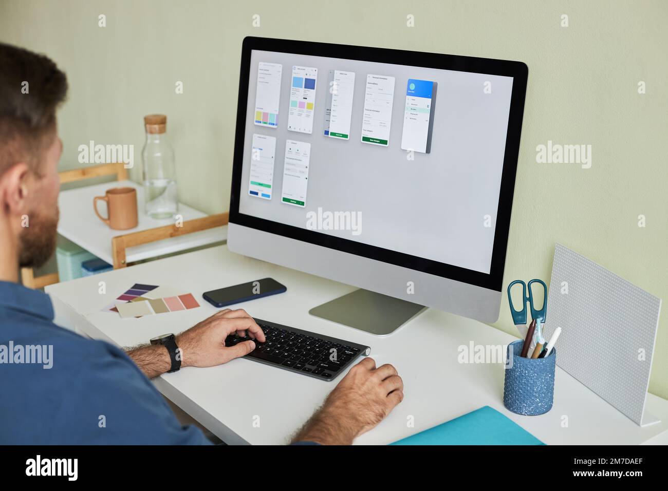 Close up of man working with PC computer at workplace while developing mobile app, copy space Stock Photo