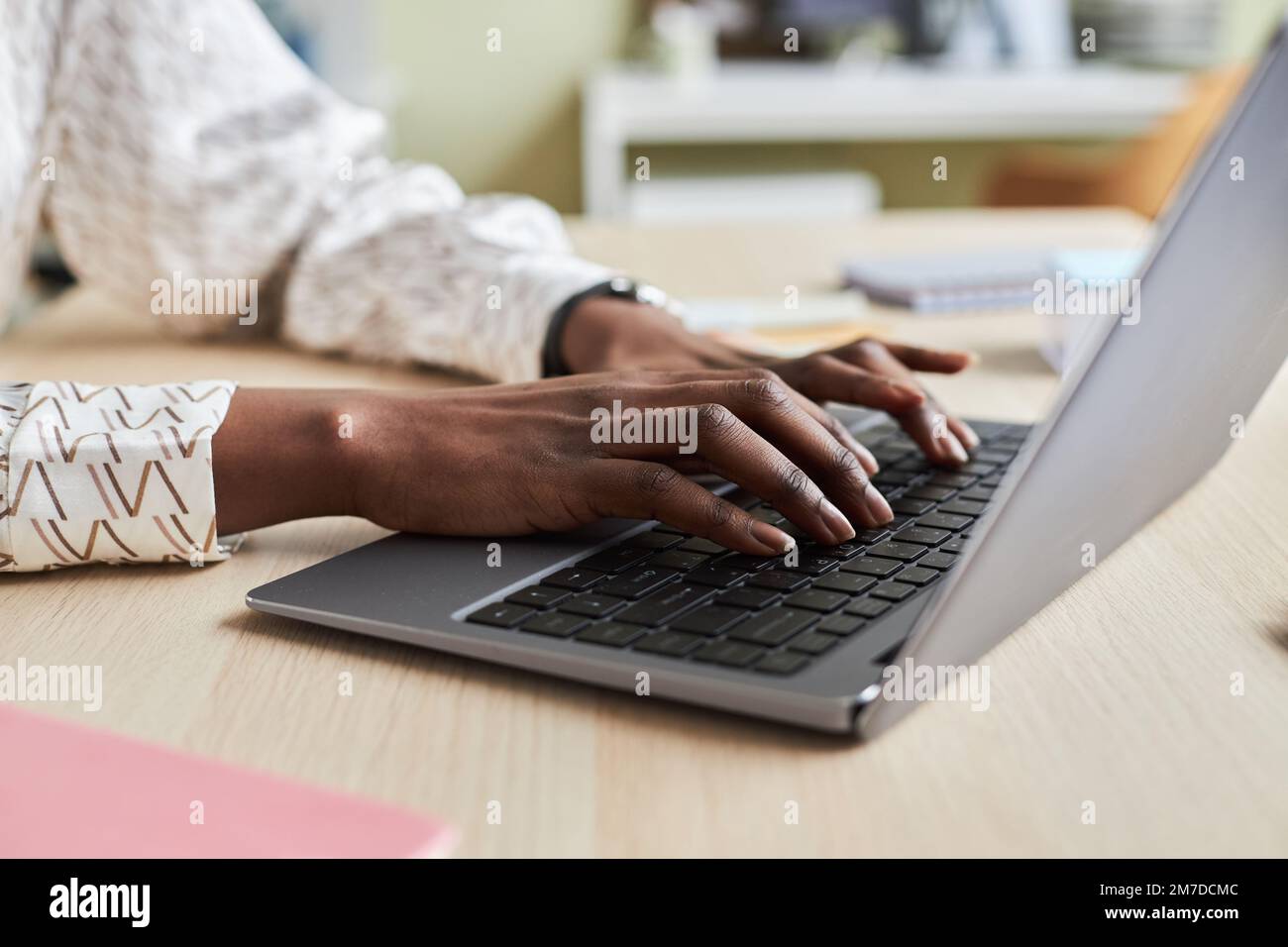 Close up of unrecognizable black young woman using laptop and typing on keyboard Stock Photo
