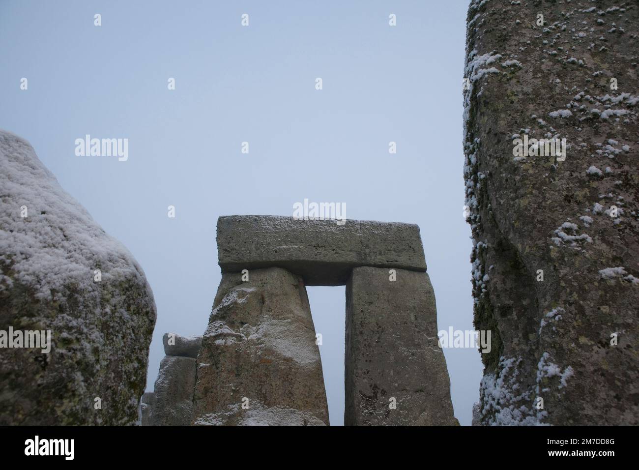 Stonehenge ancient neolithic stone circle on Salisbury plain, wiltshire, Uk and people gather for the winter solstice celebrations. Pagans gather to worship and enjoy the rising of the sun this year the stones have a light covering of snow. Stock Photo