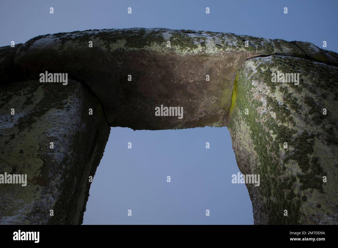 Stonehenge ancient neolithic stone circle on Salisbury plain, wiltshire, Uk and people gather for the winter solstice celebrations. Pagans gather to worship and enjoy the rising of the sun this year the stones have a light covering of snow. Stock Photo