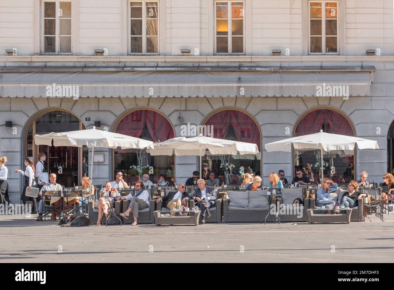 Cafe piazza Italy, view in summer of people sitting at cafe tables in the Piazza Unita d'Italia in the city of Trieste, Friuli-Venezia Giulia, Italy Stock Photo