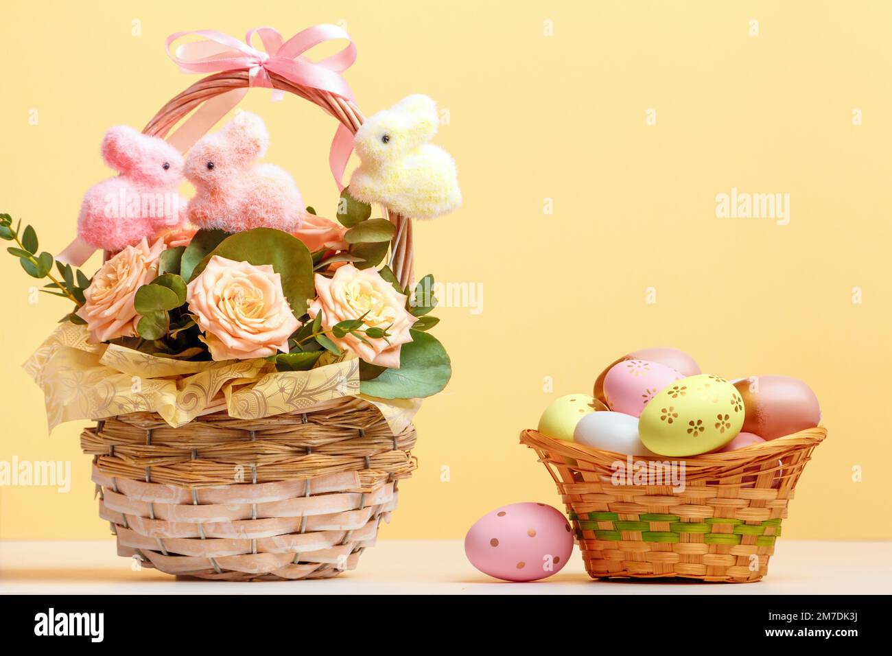 Easter composition still life. Baskets with roses and eggs on the table. Stock Photo
