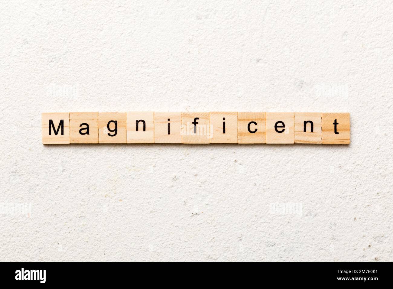 magnificent word written on wood block. magnificent text on table ...