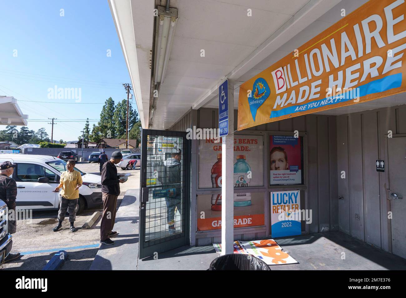 People wait in line outside the gas station that previously sold the 2
