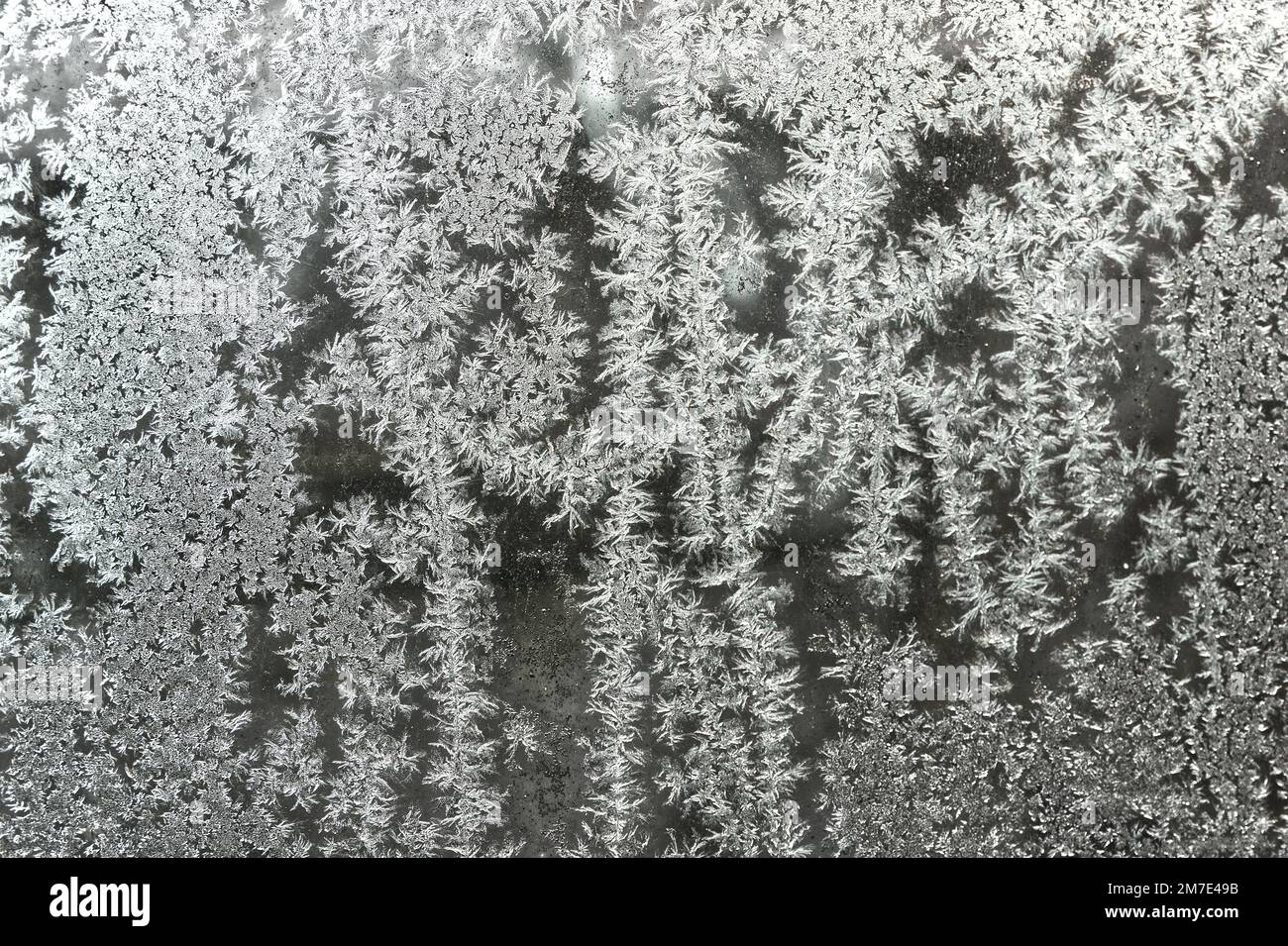 Ice crystal patterns on vehicle glass. Close up. Stock Photo