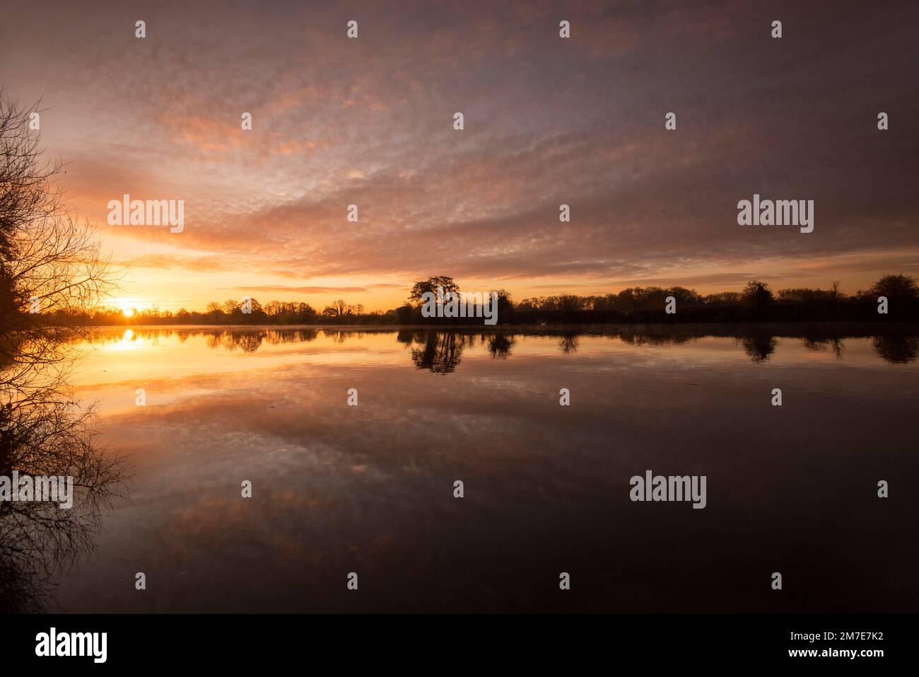 Sunrise reflections on the River Trent at Colwick Park in Nottingham, Nottinghamshire England UK
