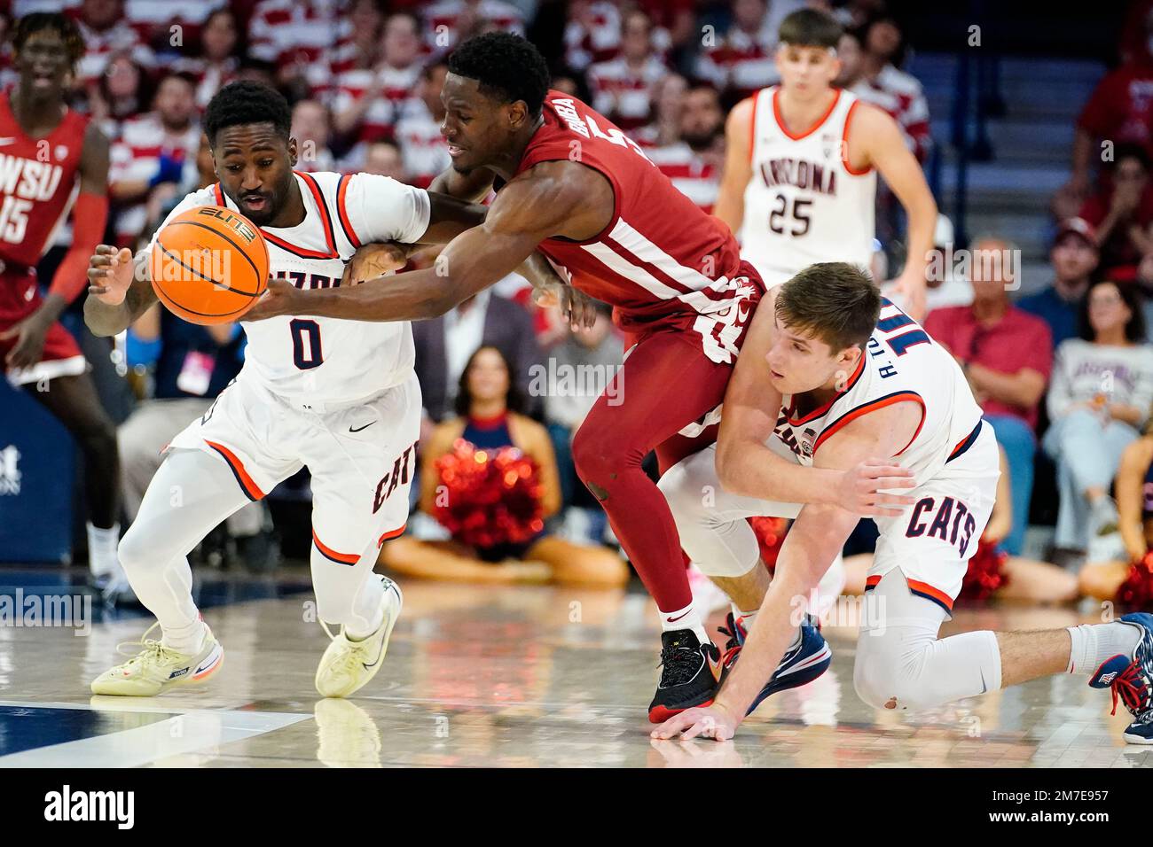 Washington State's TJ Bamba, center, battles for the ball with Arizona ...