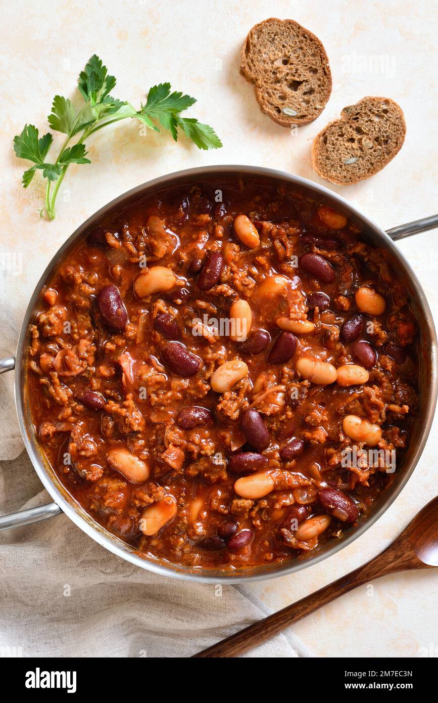 Stewed beans with ground beef, jalapeno pepper and bacon in cooking pan