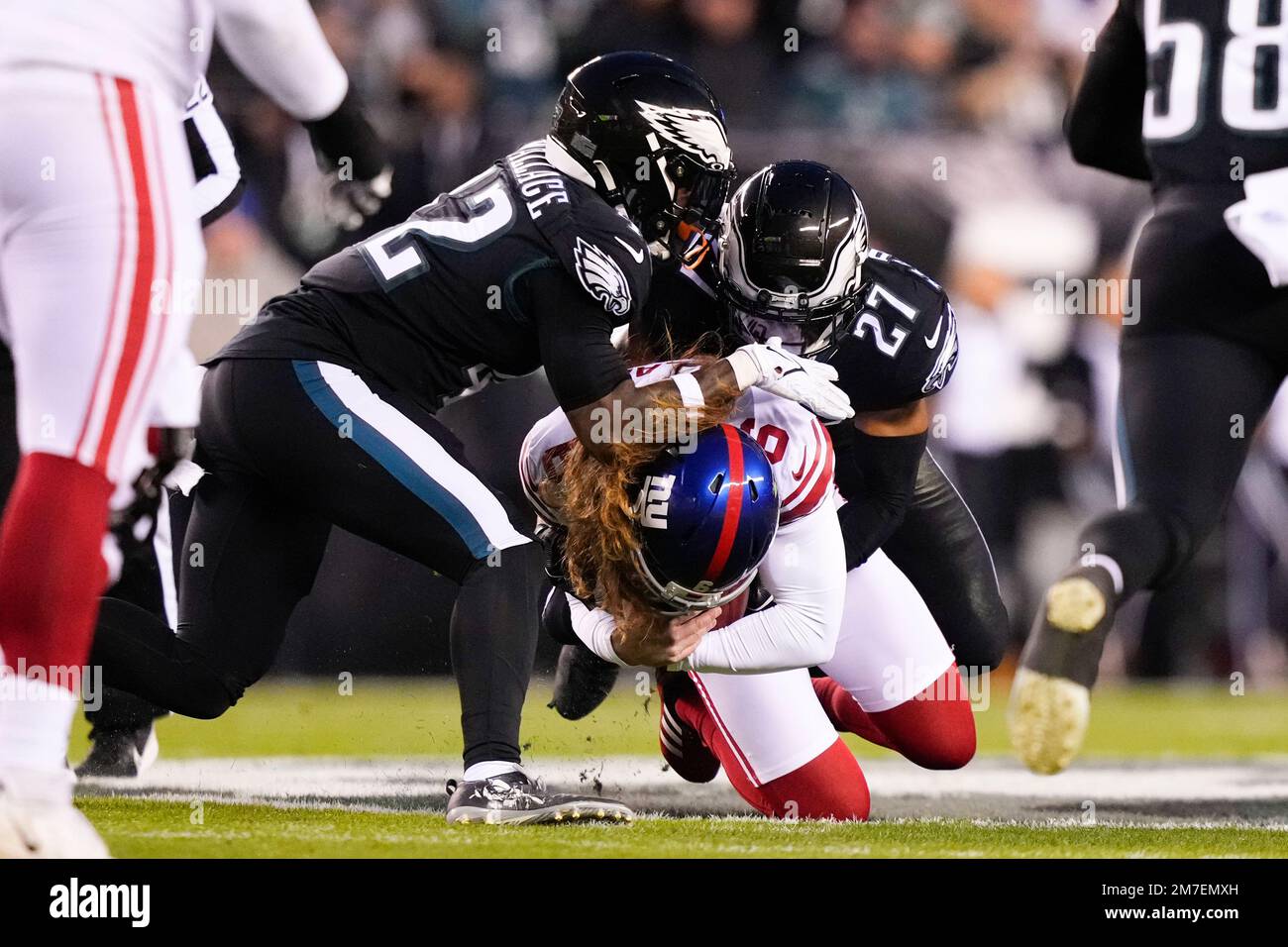 CORRECTS TO GIANTS PUNTER JAMIE GILLAN NOT PLACEKICKER GRAHAM GANO - New  York Giants punter Jamie Gillan, center, is sacked by Philadelphia Eagles'  K'Von Wallace, left, and cornerback Zech McPhearson (27) after