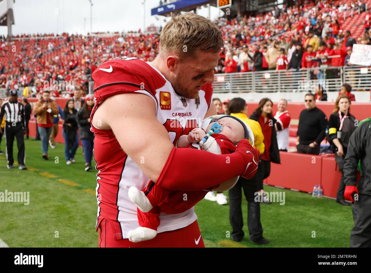 Arizona Cardinals defensive end J.J. Watt (99) holds his son, Koa