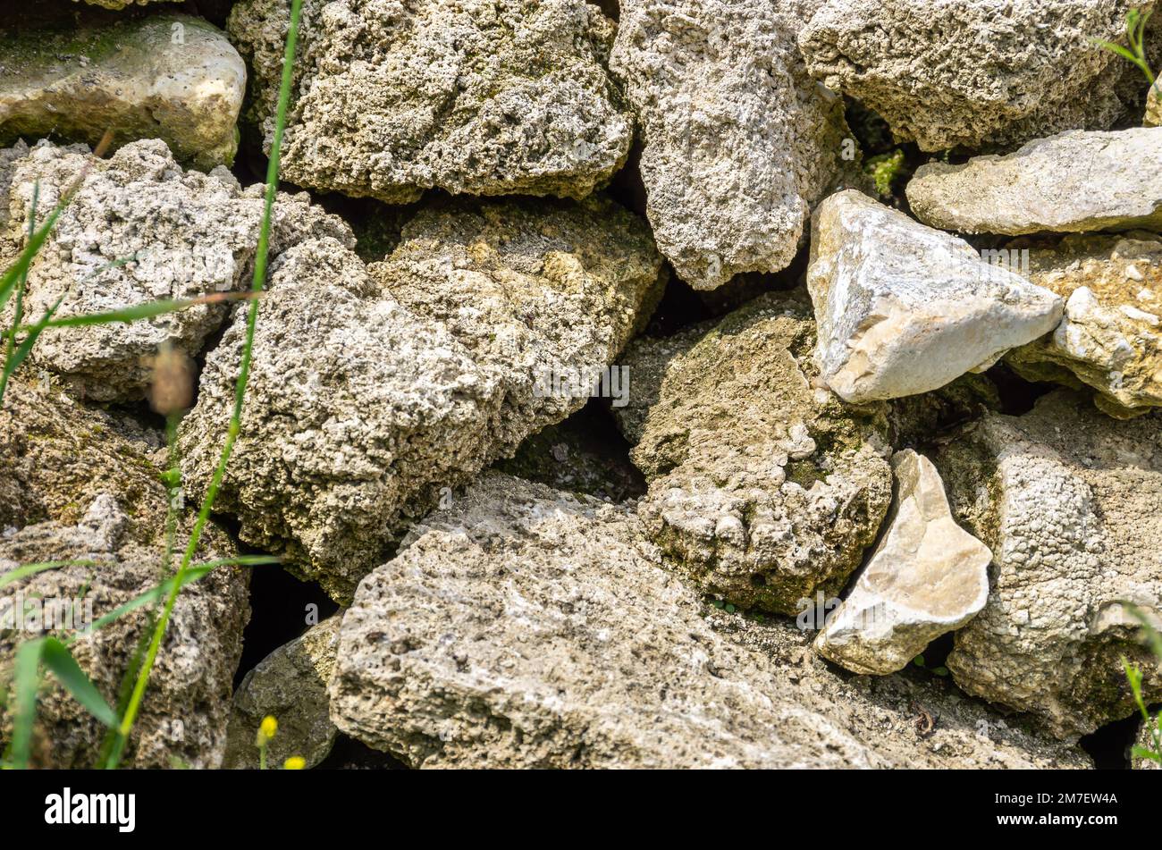 Structure of a stone wall exemplified by one in the front yard of a cottage on the Swabian Alb near Bad Urach, Baden-Wurttemberg, Germany. Stock Photo