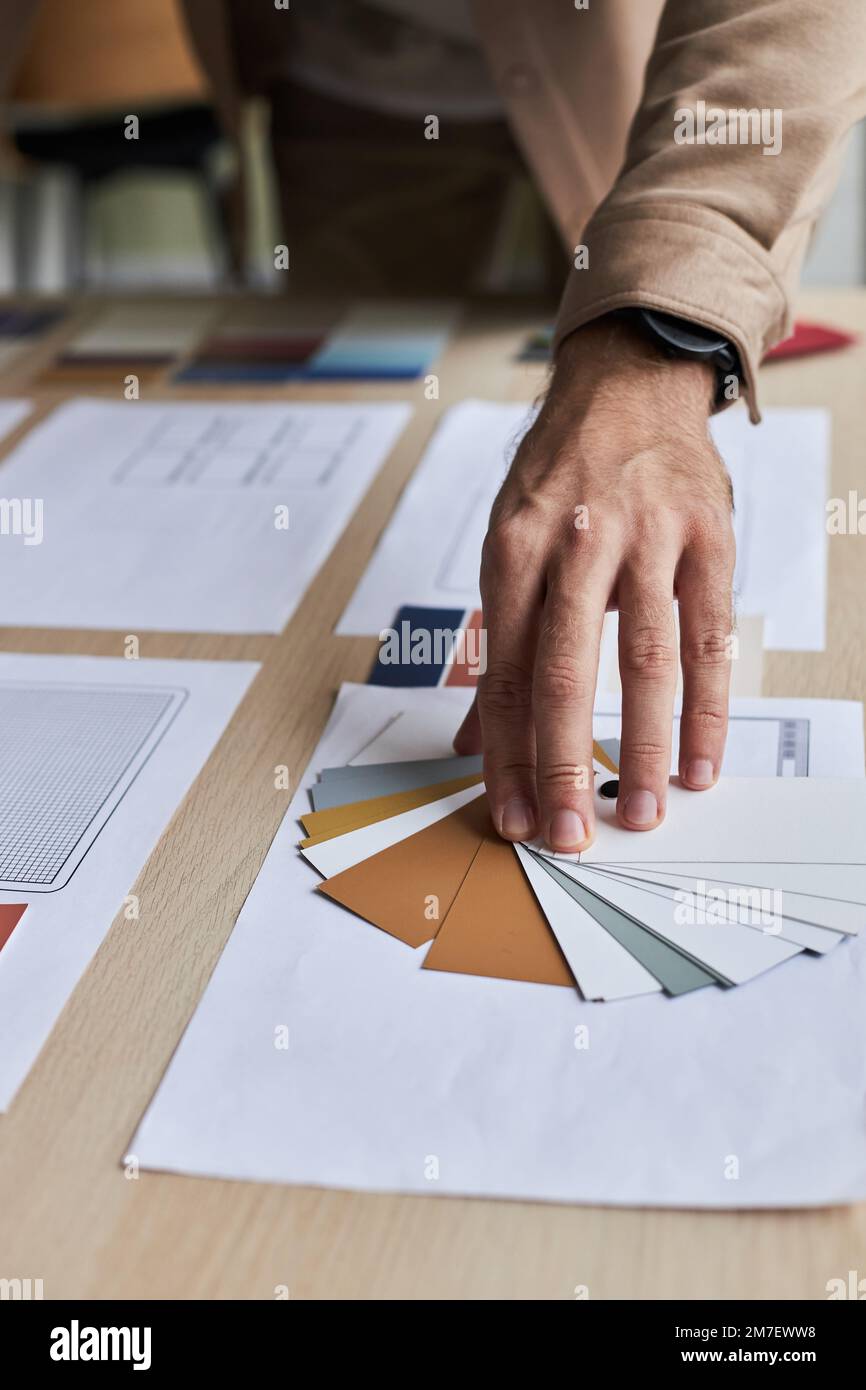 Close up of male designer choosing color palette while working on creative project Stock Photo