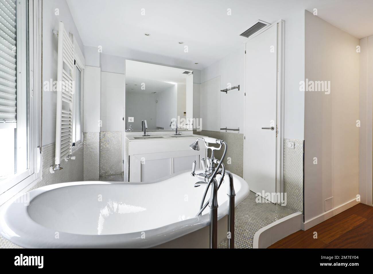 Bathroom with clawfoot bathtub, white wooden furniture with builtin