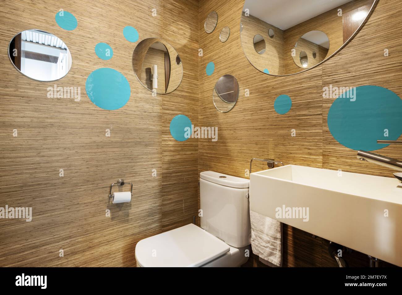 Bathroom with wood-look tile wall, designer white porcelain sinks, and ...