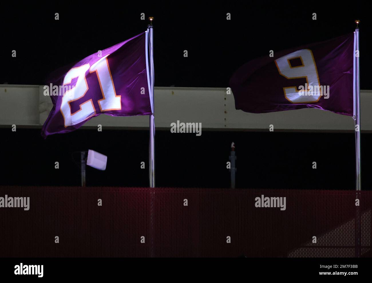 Washington Commanders flags honoring former players on display during