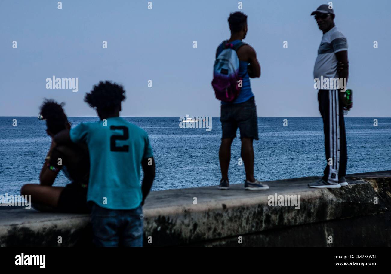 People watch the Cuban Coast Guard capture a makeshift boat, from the ...