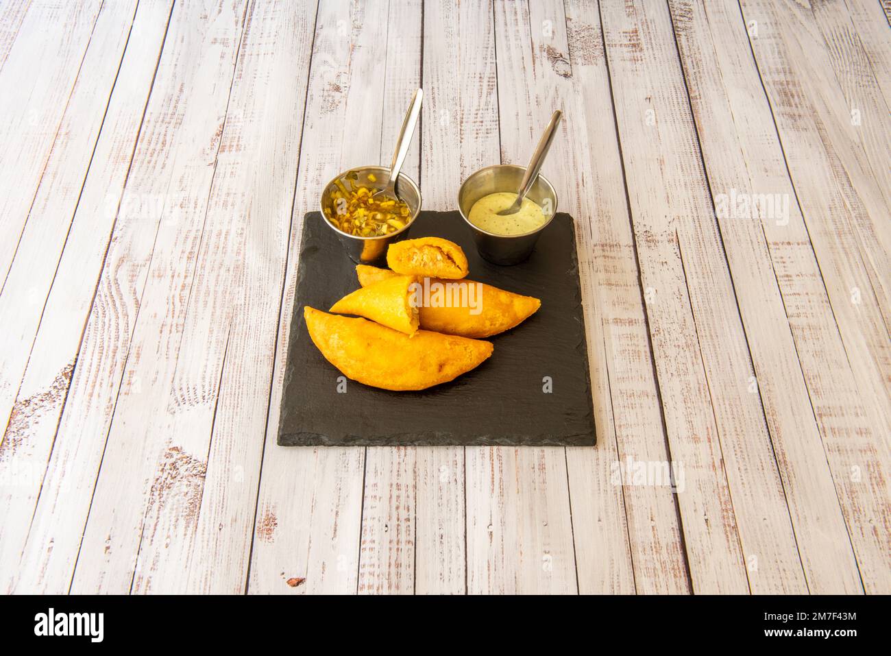 An empanada is a thin bread dough, shortcrust pastry or puff pastry