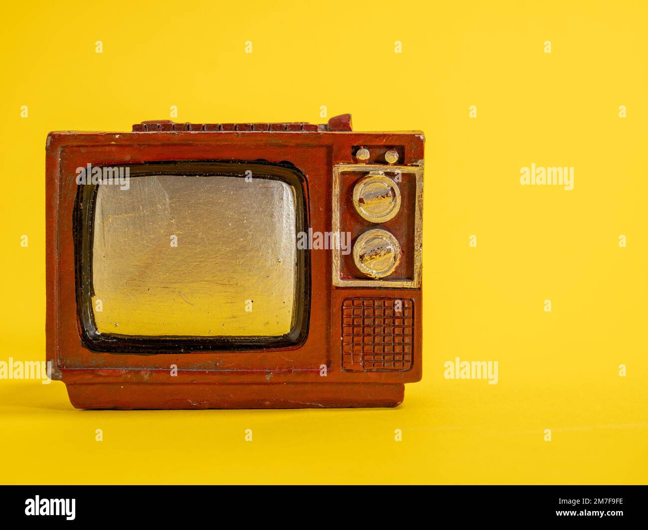 Model of an old TV. Vintage TV on a yellow background. Closeup Stock