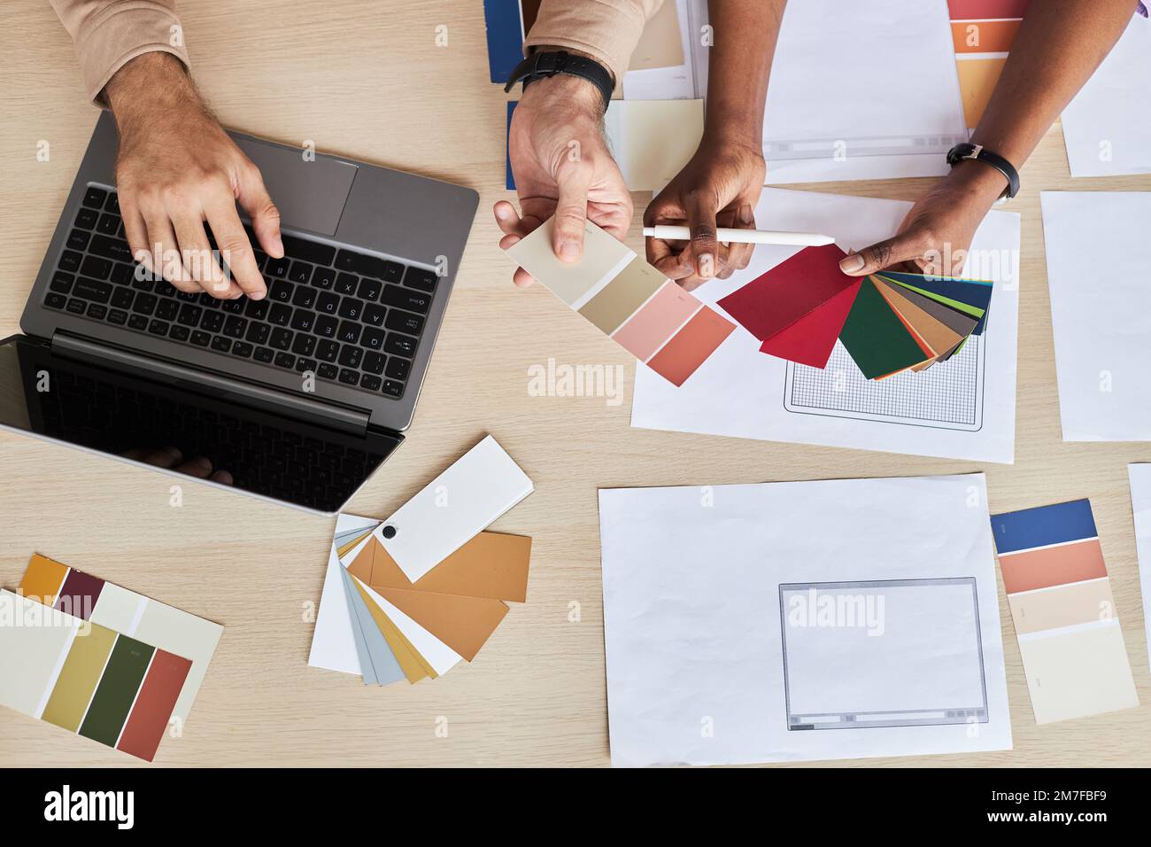 Top view at two designers choosing color swatches while working on UI project in office Stock Photo
