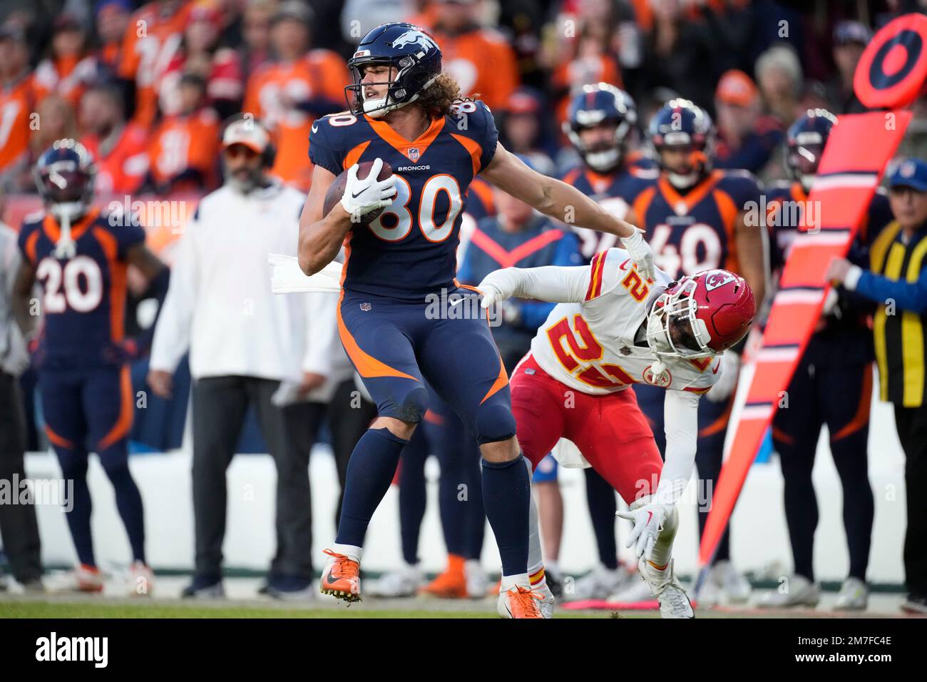 Denver Broncos tight end Greg Dulcich (80) catches a pass next to