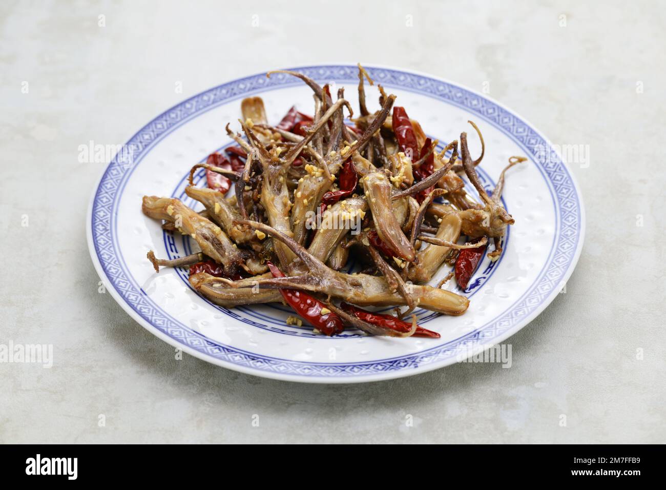 fried duck tongue with chili peppers and garlic, Chinese food Stock Photo Alamy