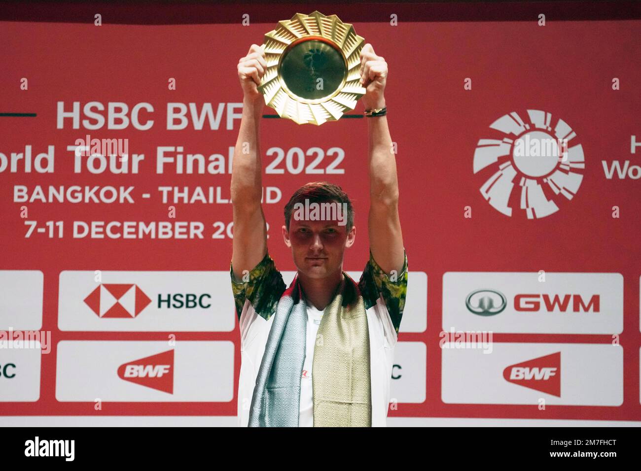 Denmarks Viktor Axelsen celebrates with his trophy after defeating Indonesias Anthony Sinisuka Ginting during their mens singles final badminton match at the BWF World Tour Finals in Bangkok, Thailand, Sunday, Dec
