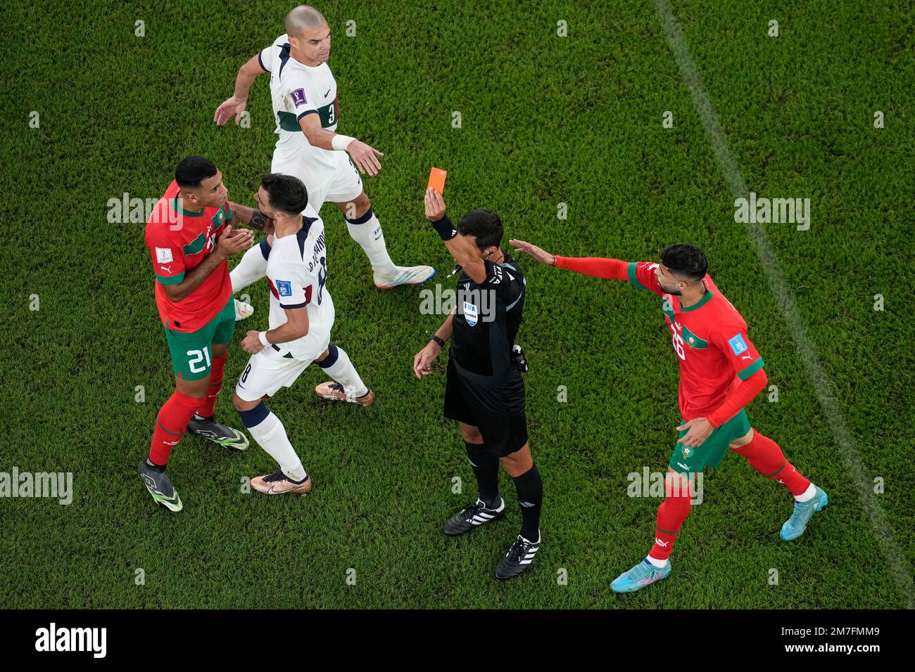 Referee Facundo Tello shows the red card to Morocco's Walid Cheddira