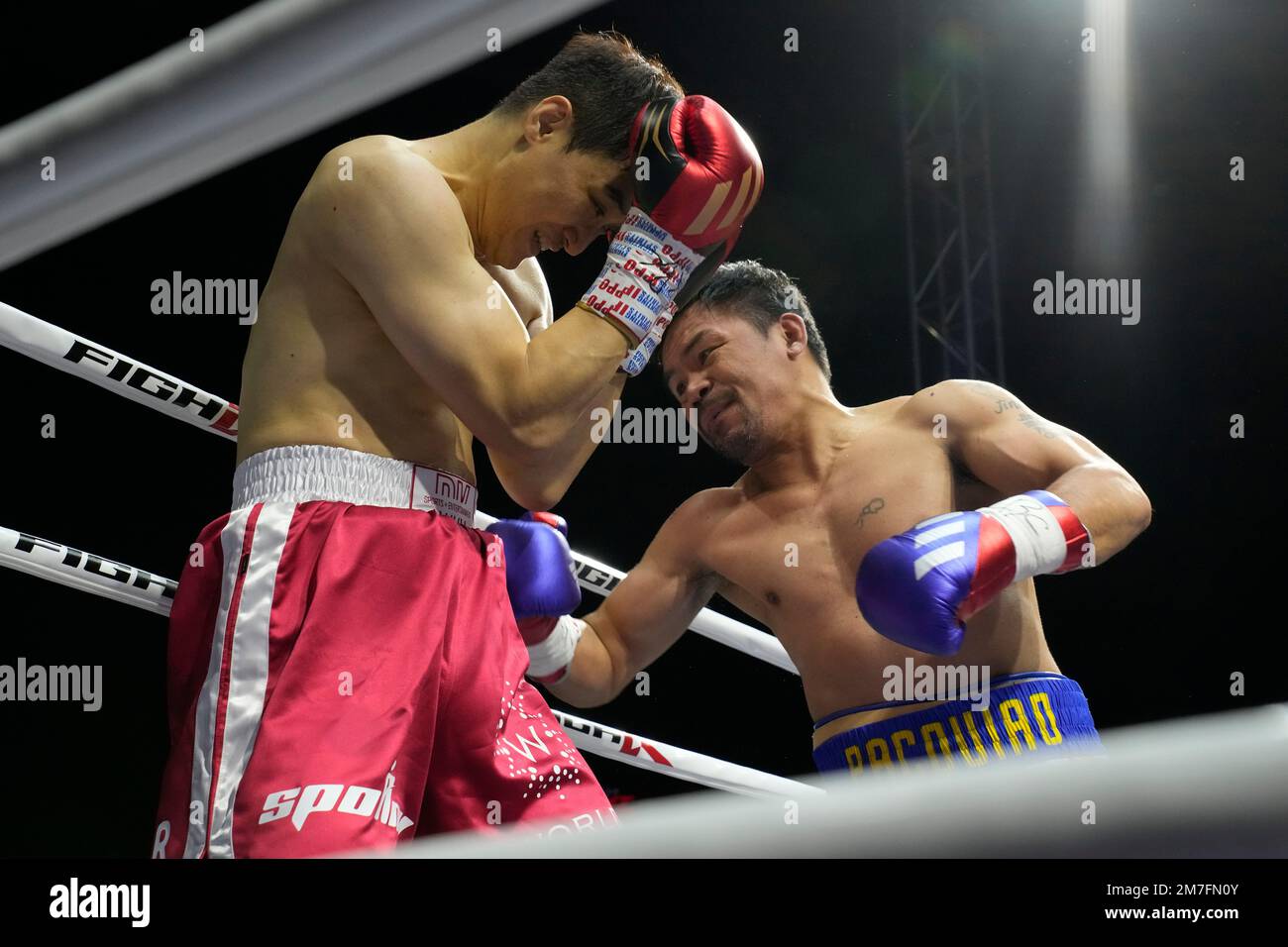 Former Filipino boxer Manny Pacquiao, right, lands his punch to South Korean martial artist D.K