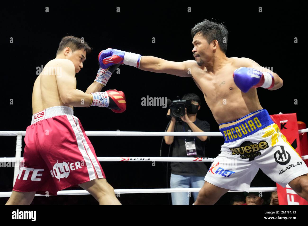 Former Filipino boxer Manny Pacquiao, right, lands his punch to South Korean martial artist D.K
