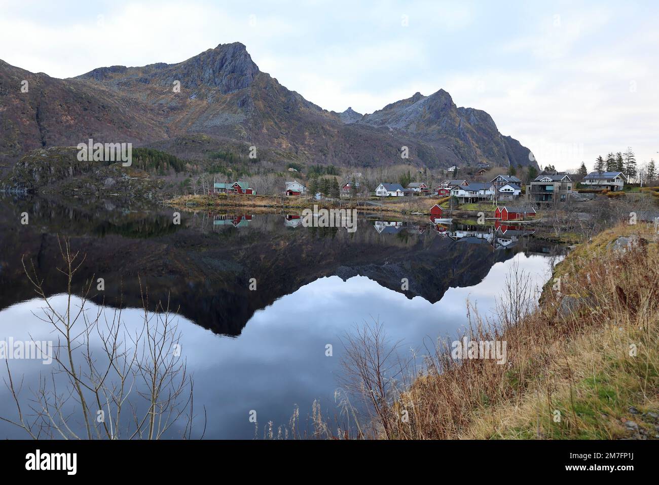 Reflection of a small village in a lake near Svolvaer in Norway Stock Photo