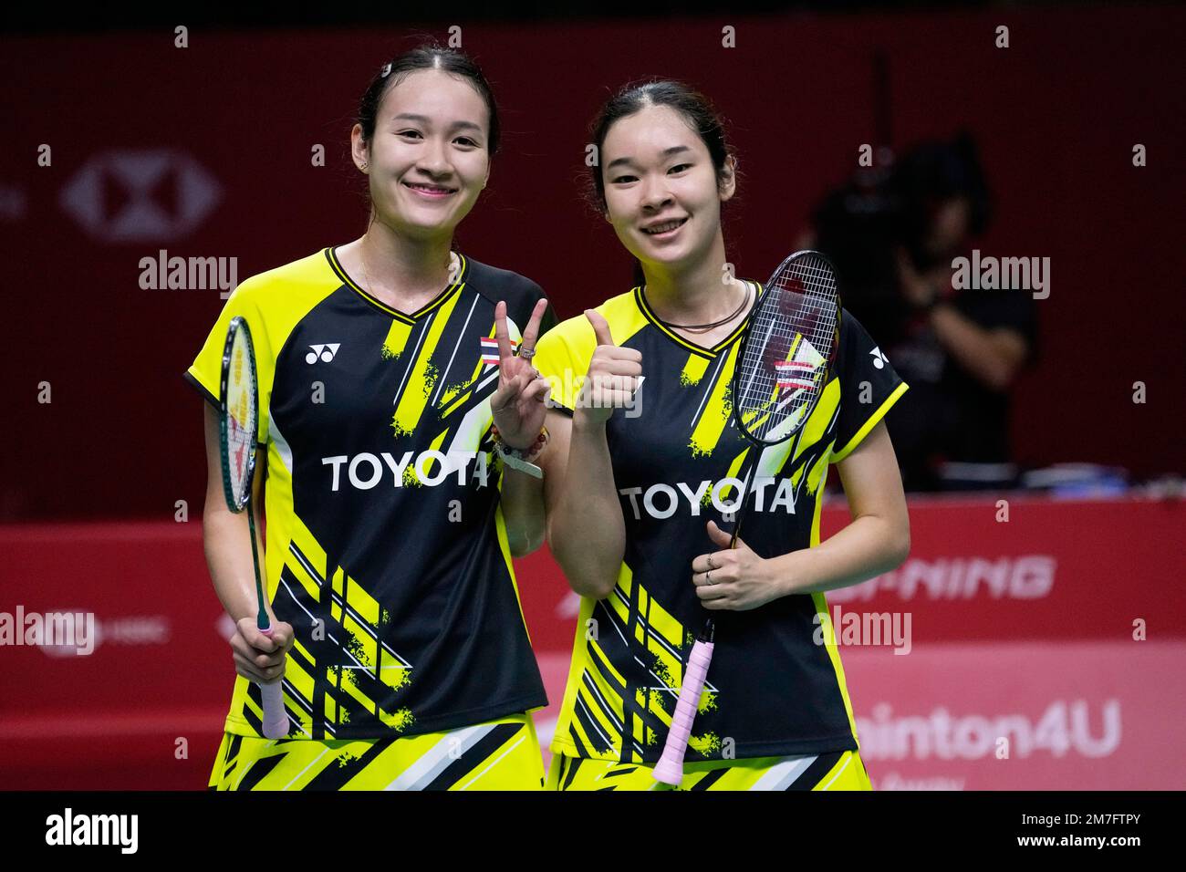 Thailands Benyapa Aimsaard, left, and Nuntakarn Aimsaard pose for a photographers after wining the match against South Koreas Kim Hye-jeong, and Jeong Na-eun during their womens doubles semi-final badminton match at the