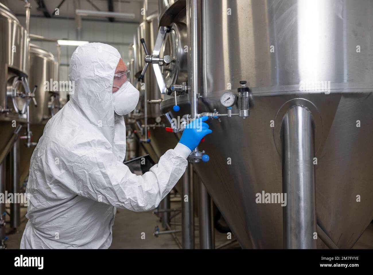 Engineer inspecting the brewing equipment in a factory Stock Photo Alamy